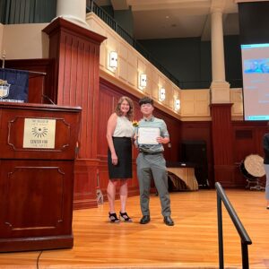 A photo of a student accepting an award.